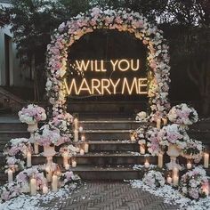 a wedding arch decorated with flowers and lit candles for an entrance to the ceremony venue