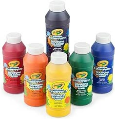 six different colors of liquid in bottles on a white background