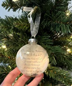 someone holding up a christmas ornament in front of a tree with the words, what do they do?