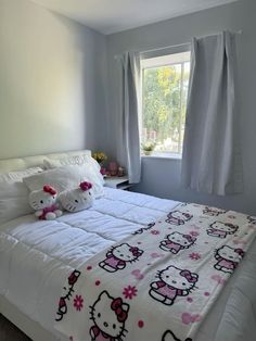 a bedroom with hello kitty bedding and curtains