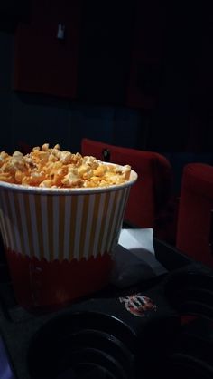 a red and white striped cup filled with popcorn