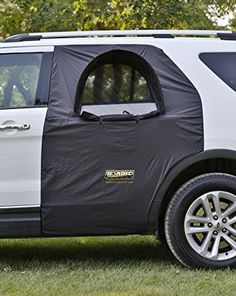 a white and black suv parked in the grass