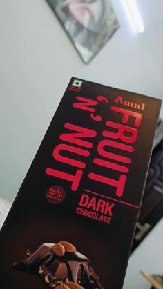 a sign advertising dark chocolate with nuts on it