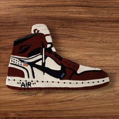 a pair of sneakers with the word air painted on them sitting on a wooden surface