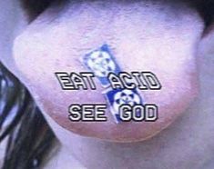 the words eat acid see god written on someone's nose