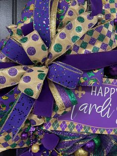 a purple and green mardi gras wreath with happy st patrick's day written on it