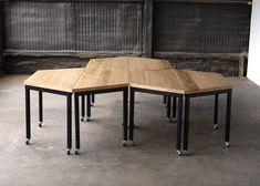 three tables made out of wood and metal