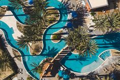 an aerial view of a resort pool with palm trees