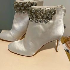 Ivory Satin Ankle Boots. Never Worn. Beautiful Crystal Embellishments Elegant Embellished Ankle-high Heels, Elegant Ankle-high Embellished Heels, Elegant White Party Boots, White Low Heel Party Boots, White Low Heel Boots For Party, Embellished Closed Toe Boots For Formal Occasions, Formal Embellished Closed Toe Boots, Elegant High Heel Boots For Wedding, Elegant High Heel Wedding Boots