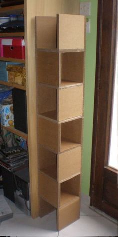 an empty shelf in the corner of a room next to a wall with several boxes on it