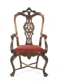 an antique chair with red upholstered seat and armrests, on a white background