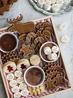 a tray filled with cookies and desserts on top of a table