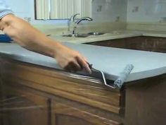 a person is using a knife to clean a kitchen counter