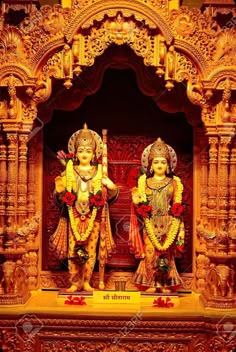 two statues of hindu deities on display in a temple stock photo - 957982