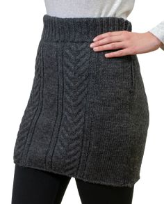 a woman is wearing a skirt made out of knits and has her hands on her hips