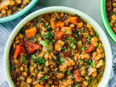 three bowls filled with beans and vegetables on top of a blue towel