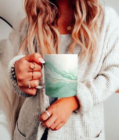 a woman holding a coffee mug in her hands