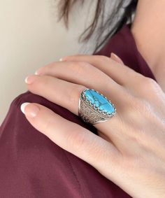 This 925 sterling silver cocktail ring with a stunning filigree pattern and a Turquoise gemstone exudes refinement and sophistication.The exquisite filigree art offers a lovely contrast, making it ideal for any formal occasion. This gorgeous accessory will enhance your look.The face of the ring is 0.80 inch long and 0.70 inch wide, and the Turquoise gemstone is 8x22 mm and has a cabochon oval shape.This ring is a work of art, with fine metal strands masterfully fashioned to create a lovely blend Bohemian Oval Jewelry With Accent Stones, Bohemian Sterling Silver Jewelry With Accent Stones, Southwestern Turquoise Jewelry For Anniversary, Elegant Turquoise Ring With Stone Setting, Silver Turquoise Ring With Accent Stones In Sterling Silver, Adjustable Fine Jewelry Turquoise Ring, Silver Southwestern Style Turquoise Ring As Gift, Silver Southwestern Turquoise Ring Gift, Adjustable Turquoise Fine Jewelry Ring