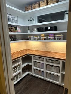 an organized pantry with lots of drawers and bins on the shelves, along with baskets