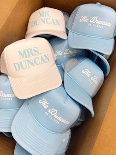 a box filled with blue hats that say mr duncan and mrs duncan on them