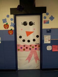 a classroom door decorated with a snowman's face and pink ribbon on it