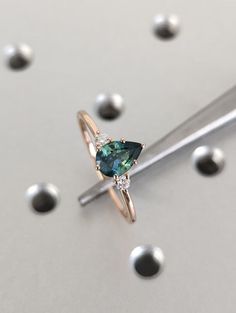 a ring with a green diamond on it