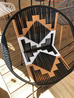 a black and white chair sitting on top of a wooden floor