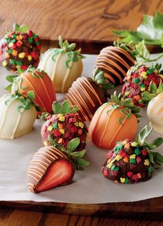 chocolate covered strawberries with sprinkles and leaves on a white paper towel