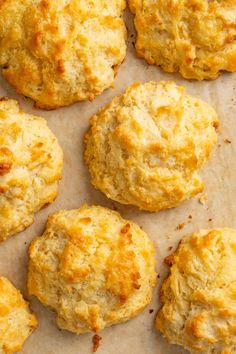 some biscuits are sitting on a piece of parchment paper and ready to be baked in the oven