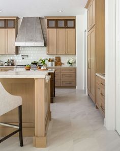 a kitchen with wooden cabinets and an island in the middle of the room is shown