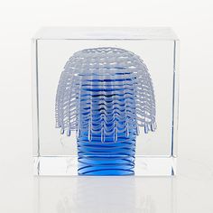 a blue vase sitting inside of a clear box