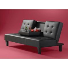 a black couch with two bottles on it