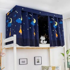 a child's bedroom with a bunk bed and space themed curtains