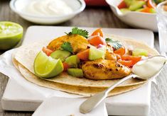 chicken fajita with avocado, tomato and cucumber on top