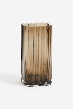 a tall glass vase sitting on top of a table