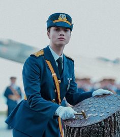 a man in uniform is holding a trunk