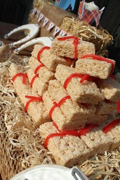 several pieces of food are stacked on top of each other with red ribbon around them