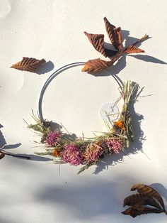 a wreath made out of leaves and dried flowers