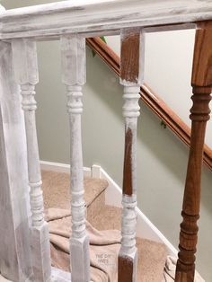 the stairs are painted white and have wooden posts on each side, along with carpeted flooring