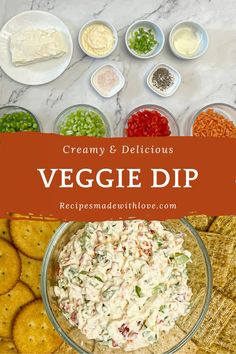 a bowl filled with veggie dip surrounded by crackers and vegetables