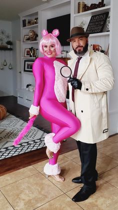 a man standing next to a woman in a pink costume