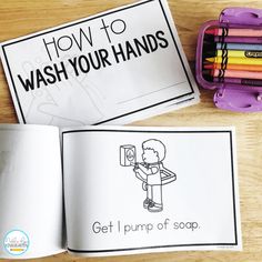 an open book with the title how to wash your hands written on it next to colored crayons