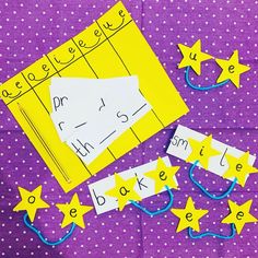 some yellow stars and numbers are on a purple table with white polka dot paper that has been cut out to spell out the letters