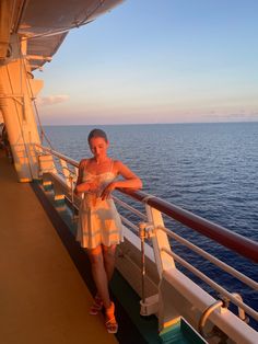 a woman standing on the deck of a cruise ship