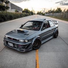 a gray car parked on the side of a road