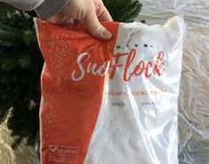 someone is holding a bag that says sand flock