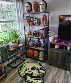 a living room filled with lots of halloween decorations and bookshelves in front of a flat screen tv