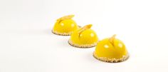 three small yellow desserts sitting on top of each other