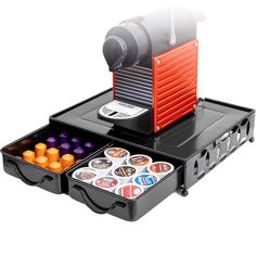 an orange and black coffee maker sitting on top of a tray filled with different items