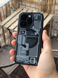 a person holding up an iphone case that has been partially removed from the back cover